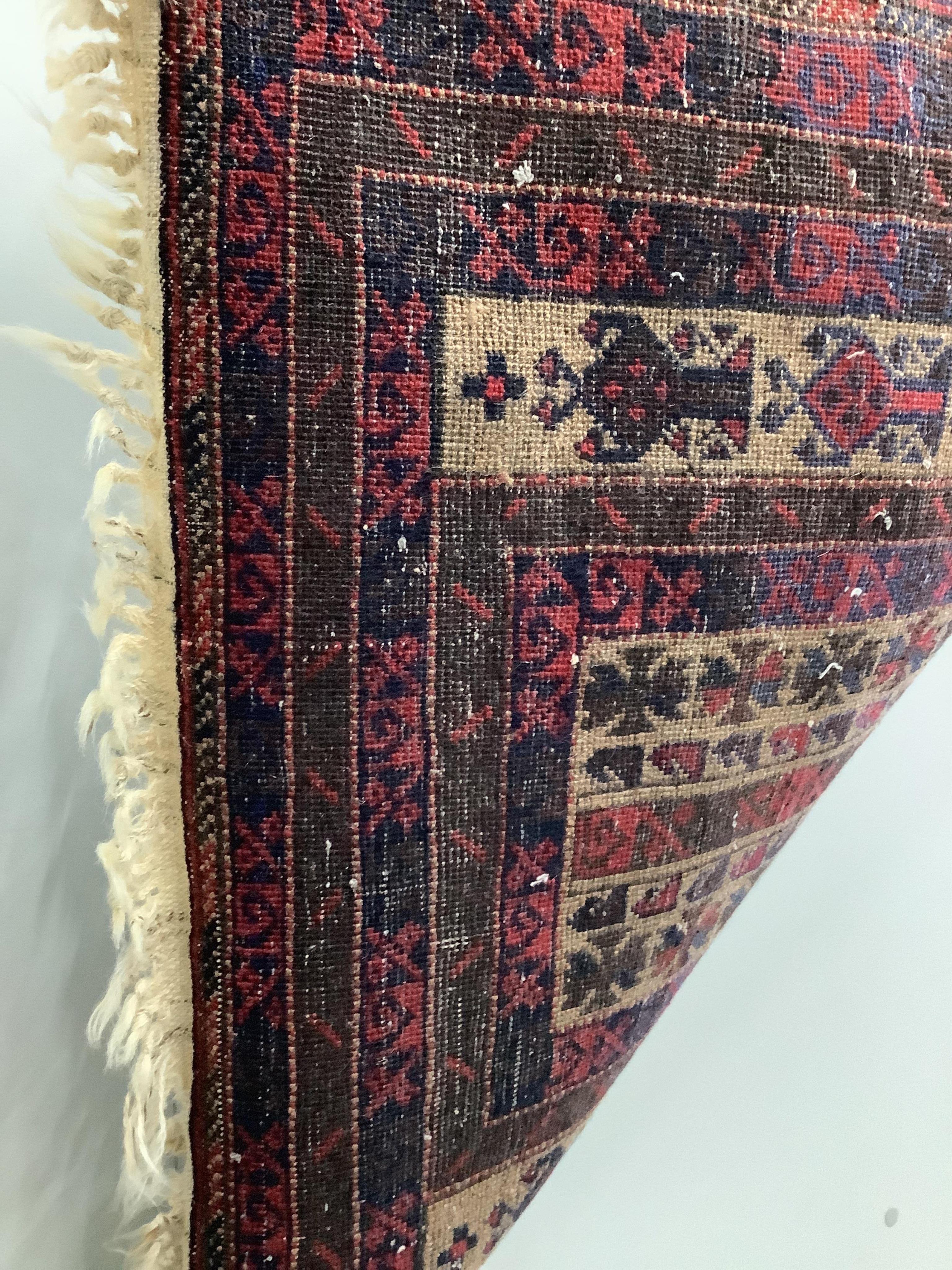 A Belouch fawn ground prayer rug, 152cm x 86cm. Condition - fair, areas of low pile